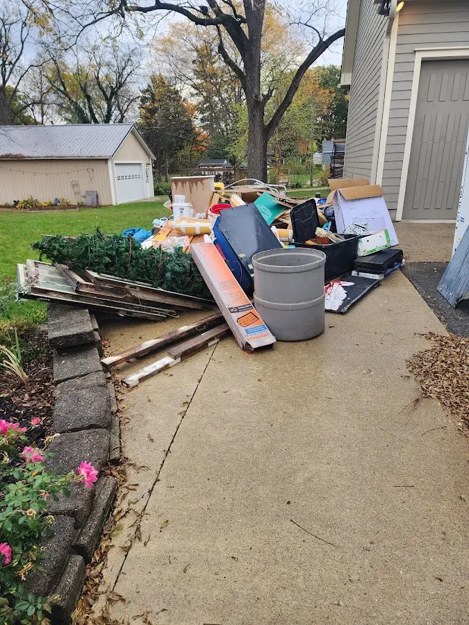 Dumpster being loaded with debris for 12 Yard Dumpster Rental in Farragut